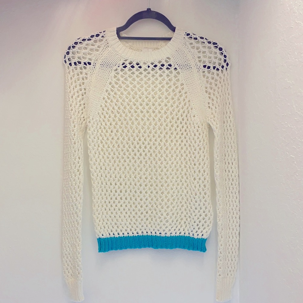White sweater with turquoise details